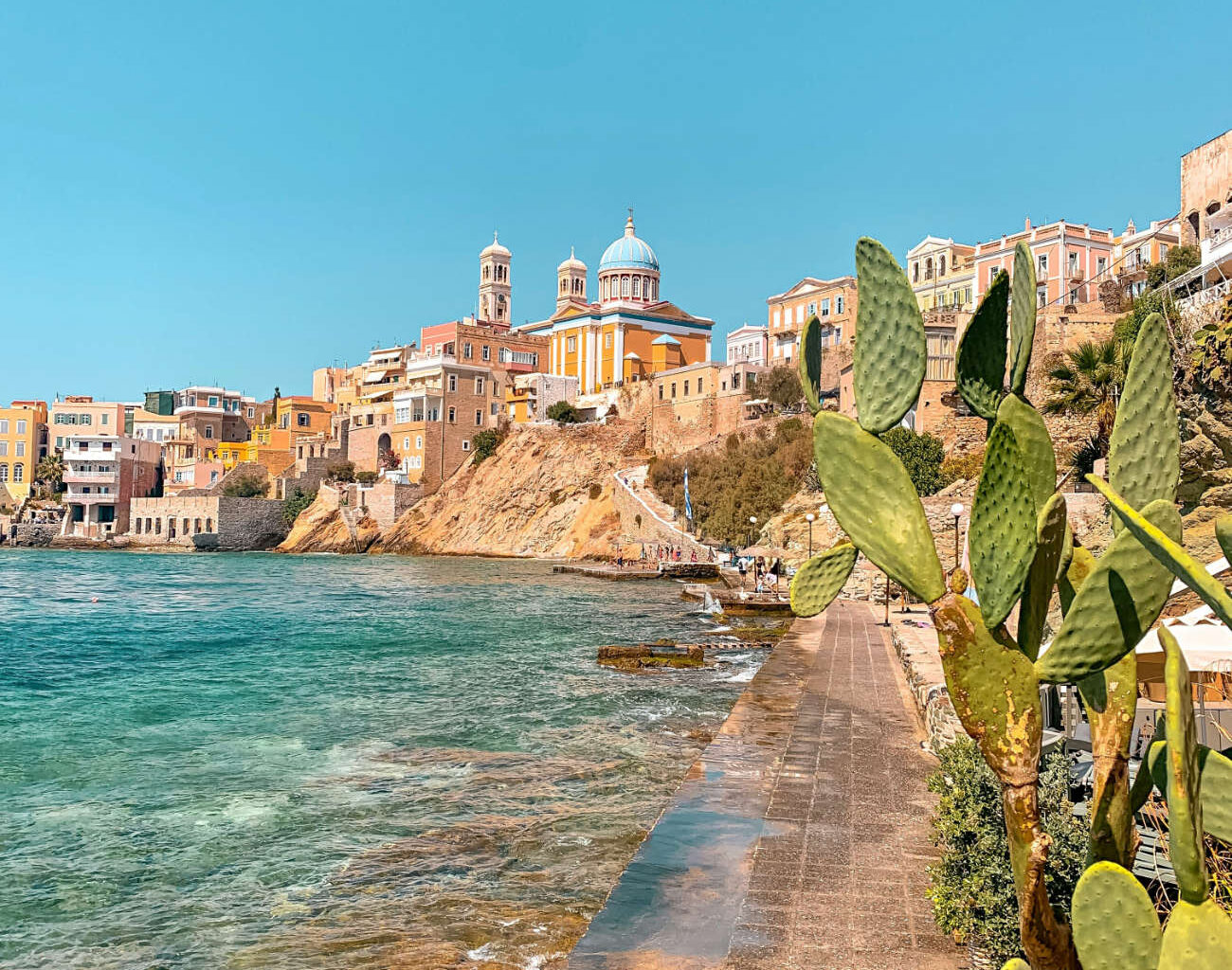 Stunning pastel neoclassical mansions rising above the harbor of Ermoupoli in Syros, a top destination among the best Greek islands for couples in 2026 seeking culture.