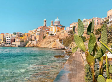 Stunning pastel neoclassical mansions rising above the harbor of Ermoupoli in Syros, a top destination among the best Greek islands for couples in 2026 seeking culture.